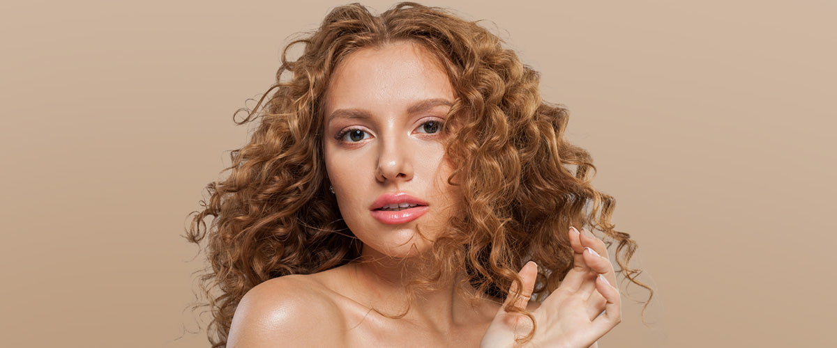 A woman with auburn, curly hair