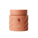 Bounce Curl Chia Seed Clumping Gel in a peach-colored jar with a matching lid, shown on a clear background.