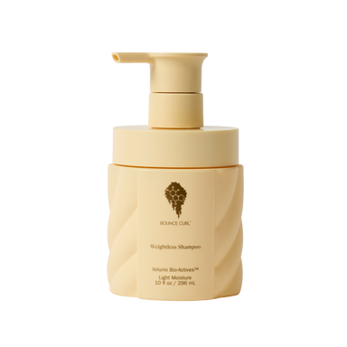 Beige shampoo bottle with pump on a white background