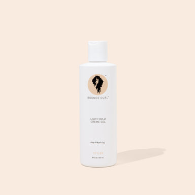 A bottle of Bounce Curl Light Hold Creme Gel with a white label and a logo depicting a curly hair icon. The cap is white, and the bottle contains 242ml of the product.