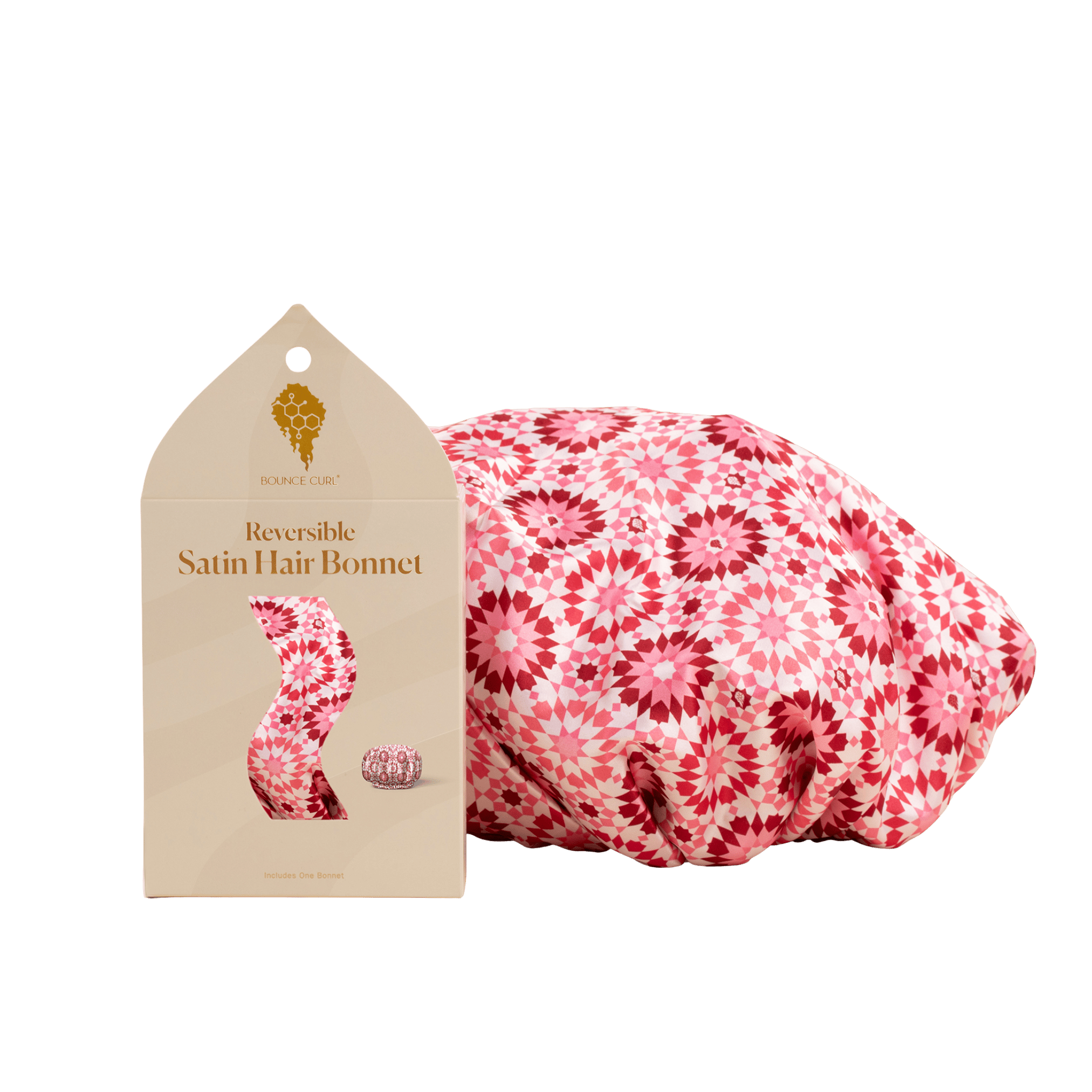 Reversible satin hair bonnet with packaging on a green background