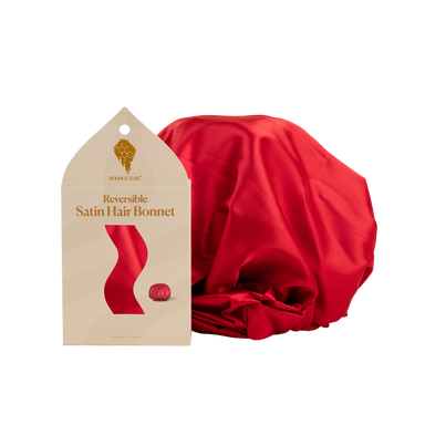 Red satin hair bonnet with packaging on a white background