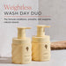 Two beige bottles with pump dispensers labeled 'Weightless Wash Day Duo' on a light background.