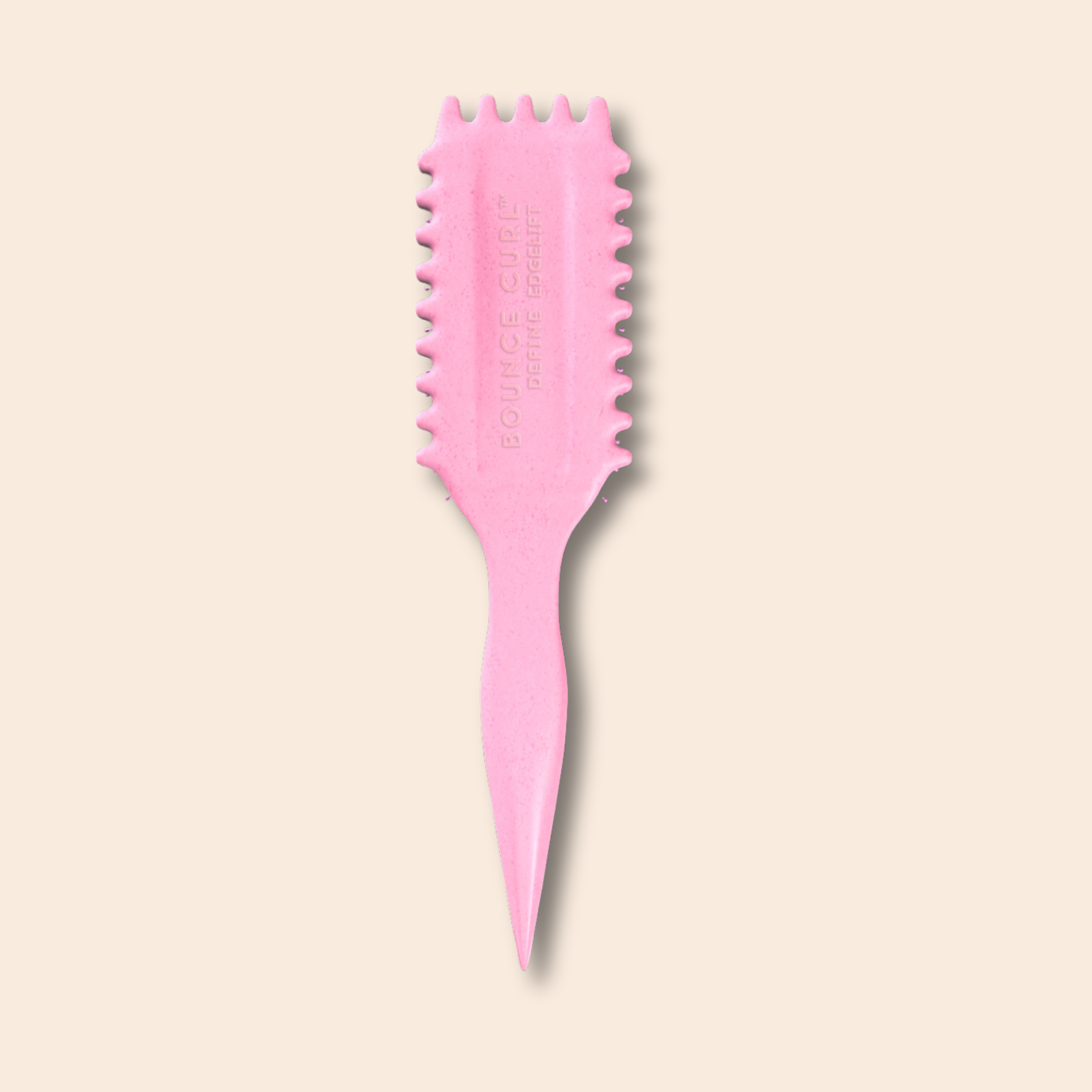 Pink hairbrush with textured bristles on a beige background