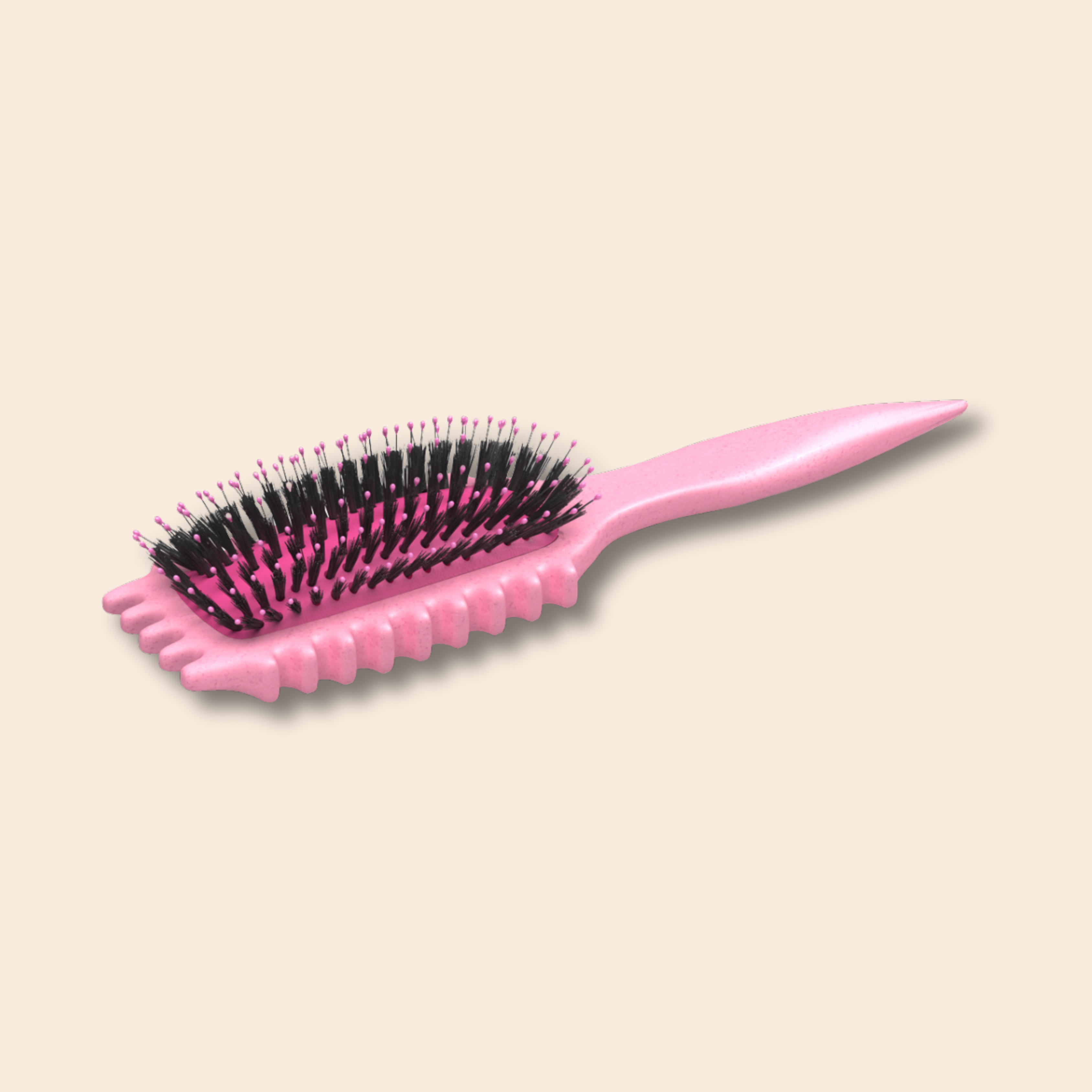 Pink hairbrush with black bristles on a beige background